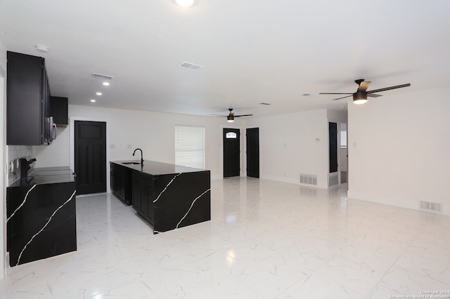 kitchen featuring ceiling fan, range, and sink