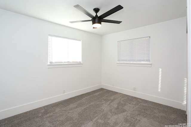 carpeted empty room featuring ceiling fan