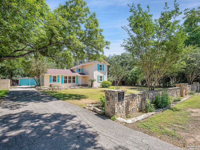 split level home featuring a garage and a front lawn