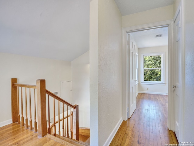 corridor with light hardwood / wood-style floors