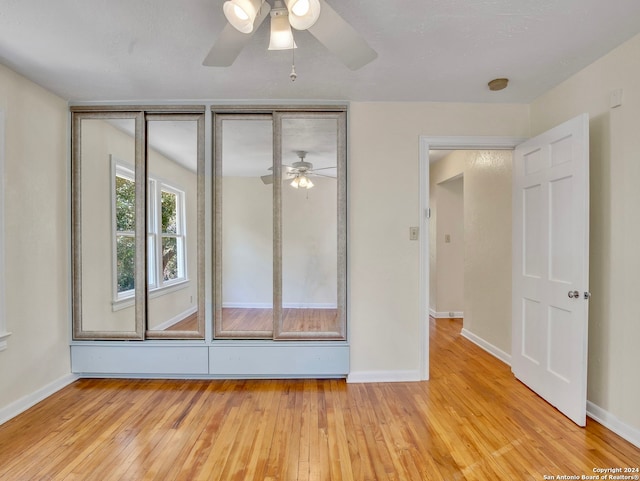 unfurnished room featuring light hardwood / wood-style floors and ceiling fan