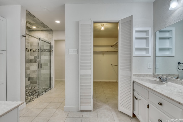 bathroom with vanity, tile patterned flooring, and a shower with door