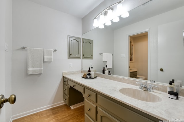 bathroom featuring hardwood / wood-style floors, vanity, and toilet