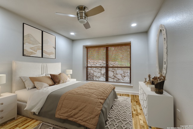 bedroom with light wood-type flooring and ceiling fan