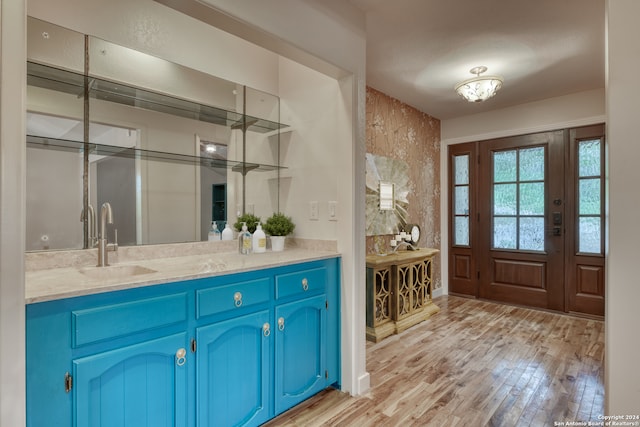 foyer entrance featuring light hardwood / wood-style floors and sink