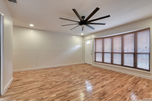 empty room featuring light wood-type flooring and ceiling fan