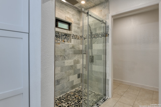 bathroom with tile patterned flooring and an enclosed shower