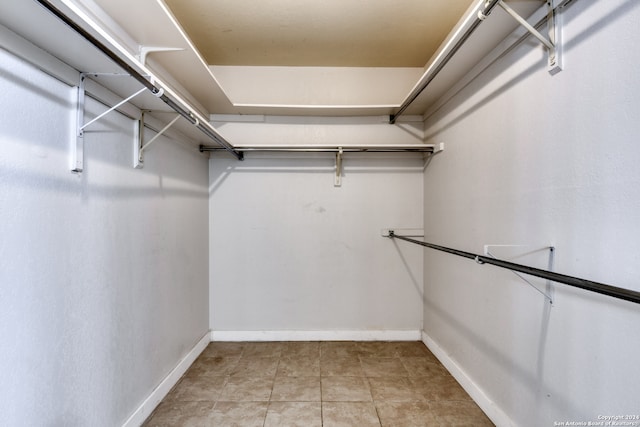 walk in closet with light tile patterned floors