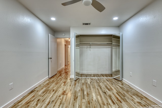 unfurnished bedroom featuring ceiling fan, a closet, and light hardwood / wood-style flooring