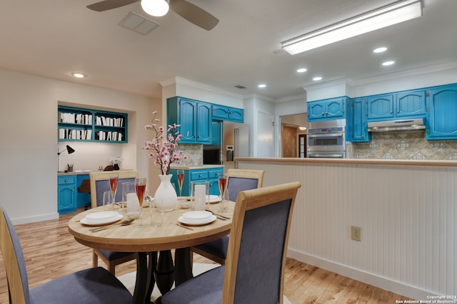 dining space with ceiling fan, light wood-type flooring, and ornamental molding