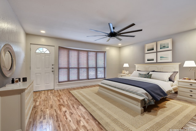 bedroom featuring multiple windows, light hardwood / wood-style flooring, and ceiling fan