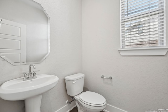 bathroom featuring sink and toilet