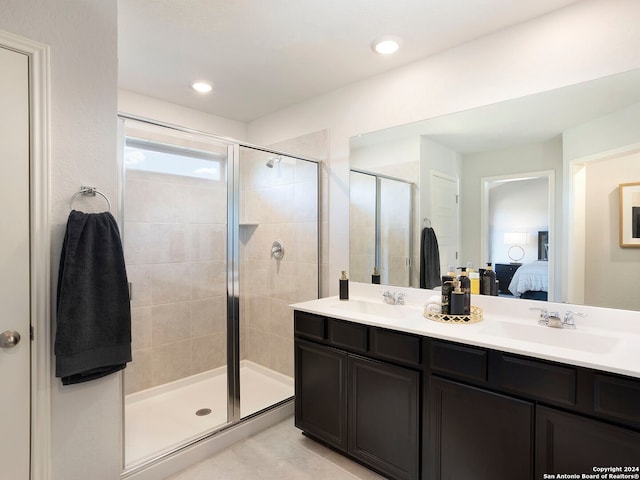 bathroom featuring tile patterned flooring, vanity, and an enclosed shower