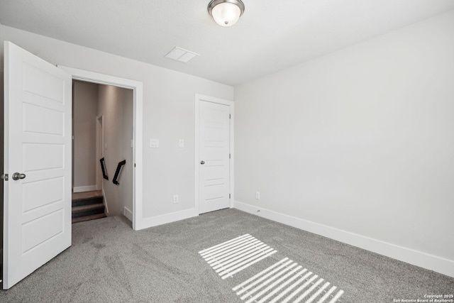 unfurnished bedroom featuring light carpet