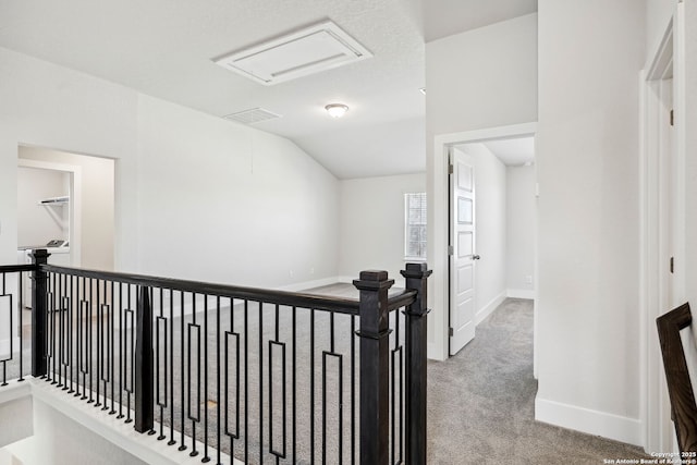 hall with light carpet and lofted ceiling