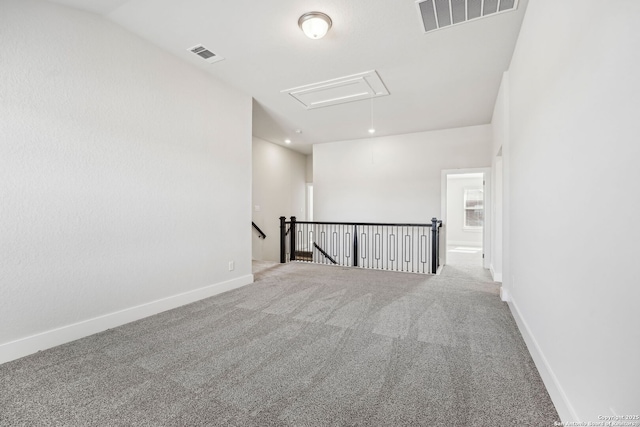 carpeted spare room featuring vaulted ceiling