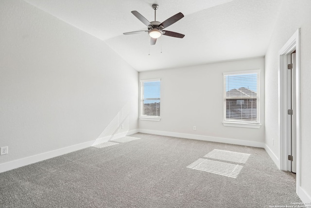 unfurnished room with vaulted ceiling, light colored carpet, and ceiling fan