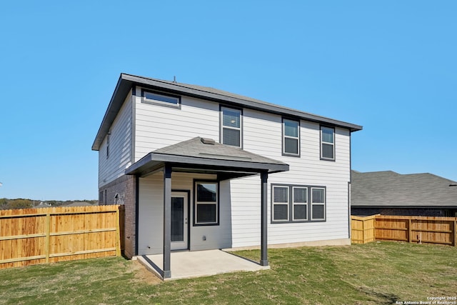 back of property with a patio and a lawn