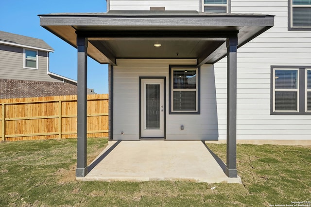 doorway to property featuring a yard and a patio