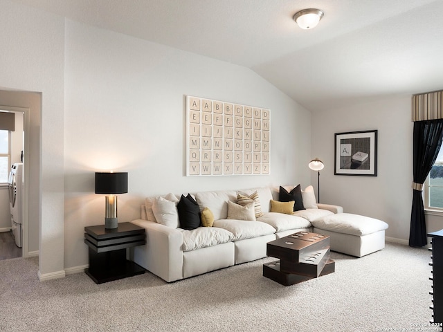 carpeted living room with washer / dryer and vaulted ceiling