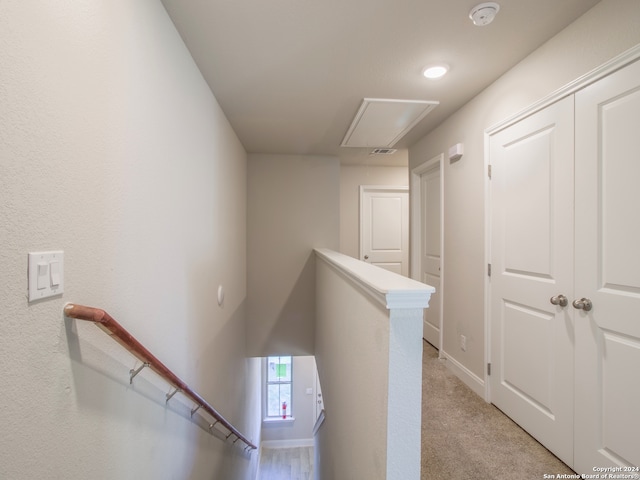 hallway with light colored carpet