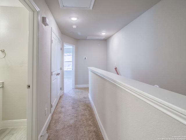 hallway featuring light carpet