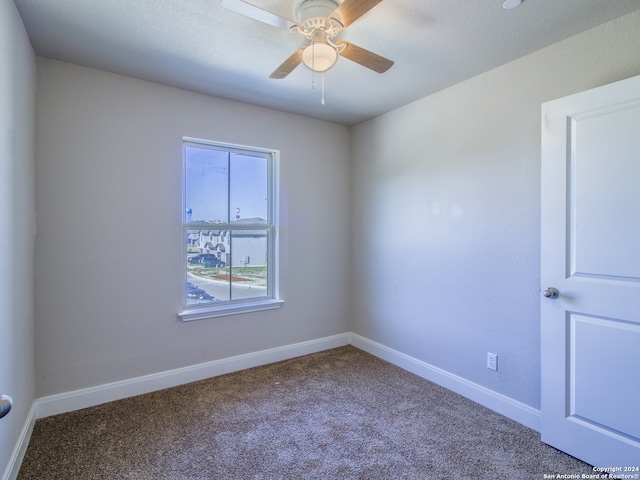 spare room with carpet flooring and ceiling fan