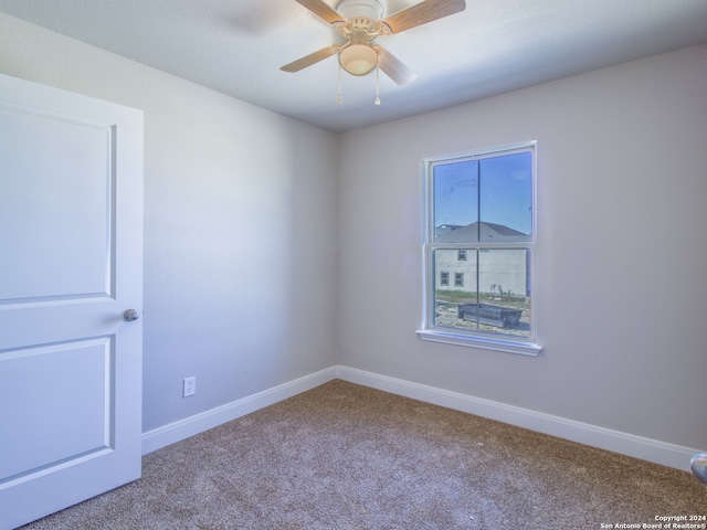 spare room with carpet flooring and ceiling fan