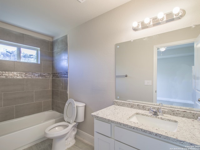 full bathroom with vanity, toilet, and tiled shower / bath