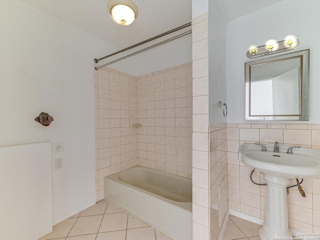 bathroom with tiled shower / bath combo, tile walls, ornamental molding, and tile patterned flooring