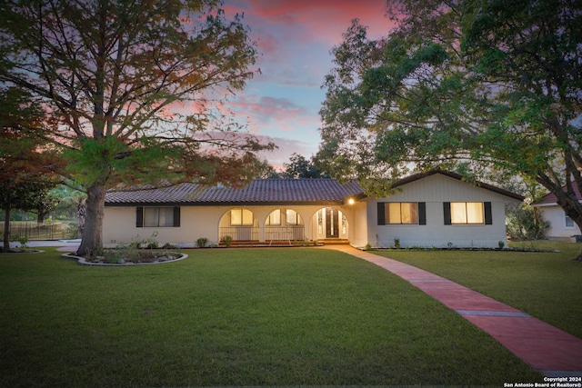 view of front of home featuring a lawn and a porch