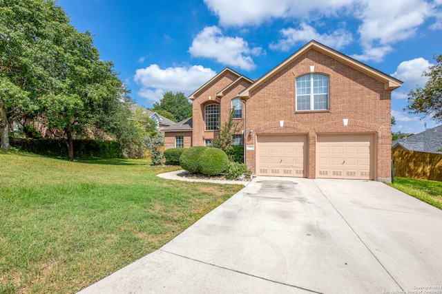 front facade featuring a front yard and a garage