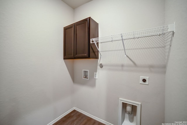 laundry area with washer hookup, hookup for an electric dryer, cabinets, and hardwood / wood-style floors