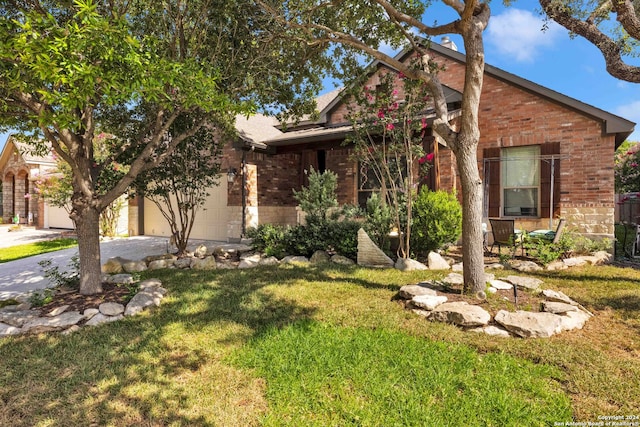 view of front of house with a front yard and a garage