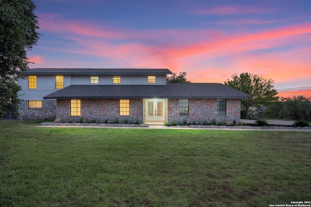 front of property featuring french doors and a yard