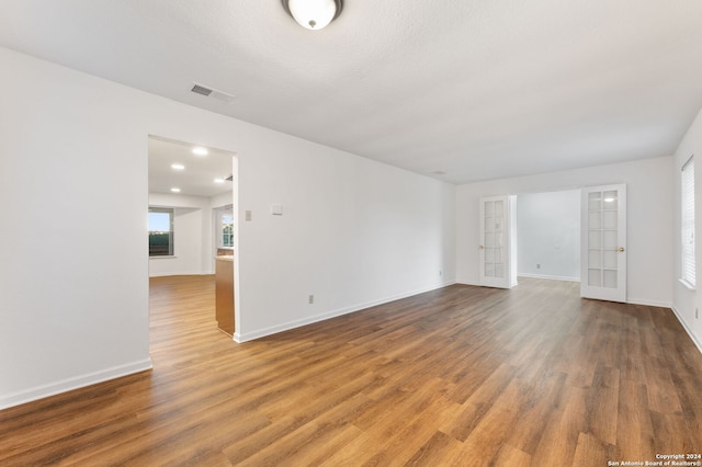 empty room featuring hardwood / wood-style floors and french doors