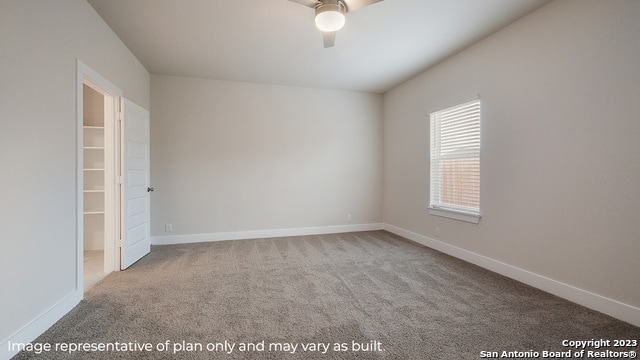 unfurnished room featuring a ceiling fan, carpet, and baseboards