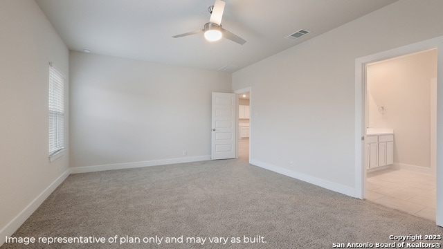 carpeted spare room featuring ceiling fan