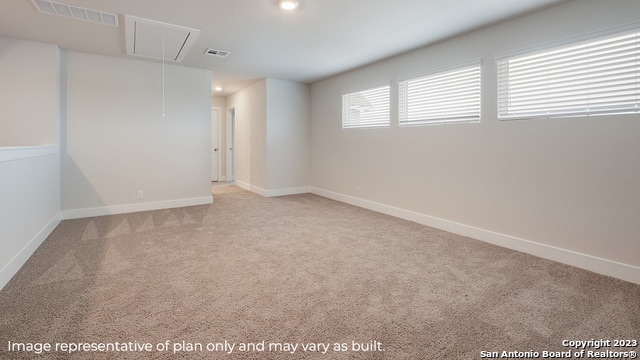 carpeted spare room with attic access, recessed lighting, and baseboards