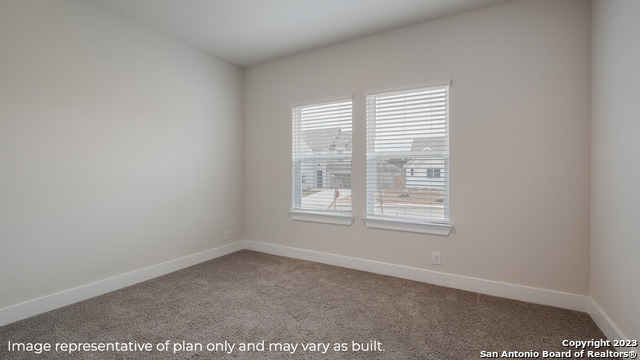 unfurnished room with carpet floors and baseboards