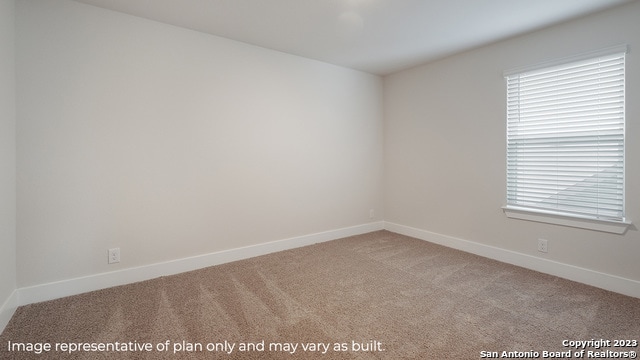 unfurnished room with light carpet and baseboards