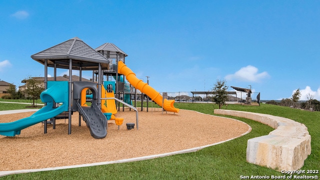 communal playground featuring a lawn