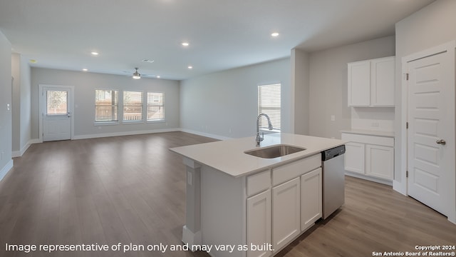 kitchen featuring white cabinetry, sink, stainless steel dishwasher, and a center island with sink