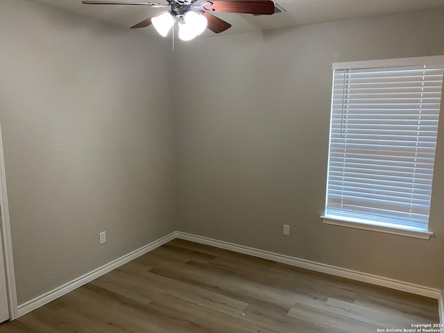 unfurnished room featuring hardwood / wood-style floors and ceiling fan