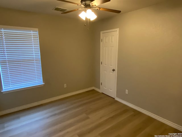 unfurnished room with ceiling fan and hardwood / wood-style floors