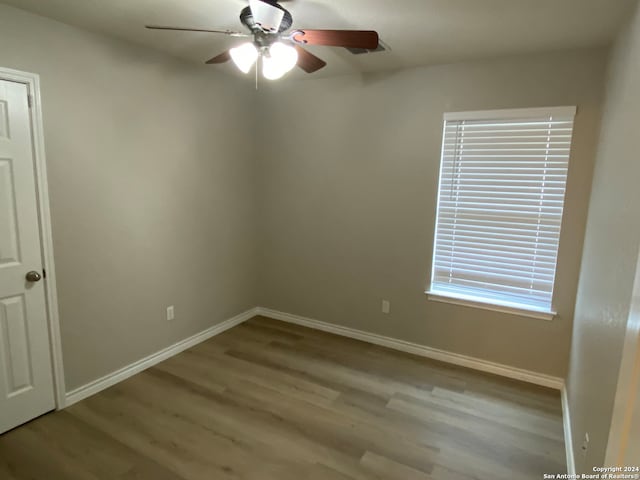 spare room with ceiling fan, light hardwood / wood-style floors, and plenty of natural light