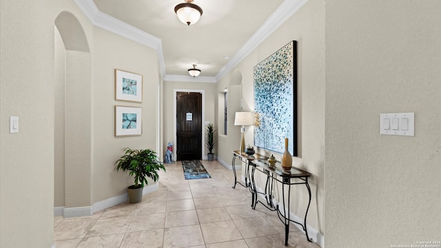 tiled foyer entrance featuring ornamental molding