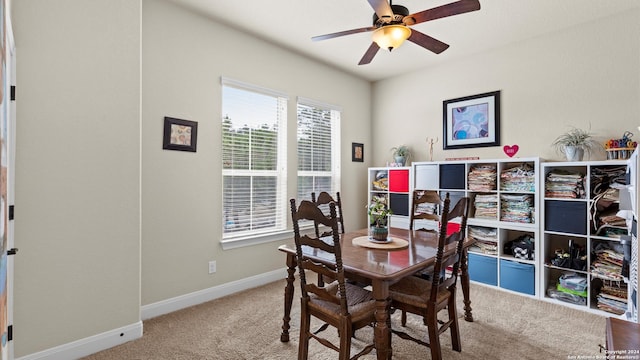 carpeted dining room featuring ceiling fan