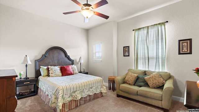 bedroom with ceiling fan and light carpet