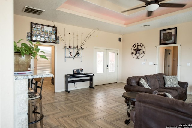 2989 Graytown, Converse, TX 78109 - living room with visible vents, a ceiling fan, baseboards, and a tray ceiling